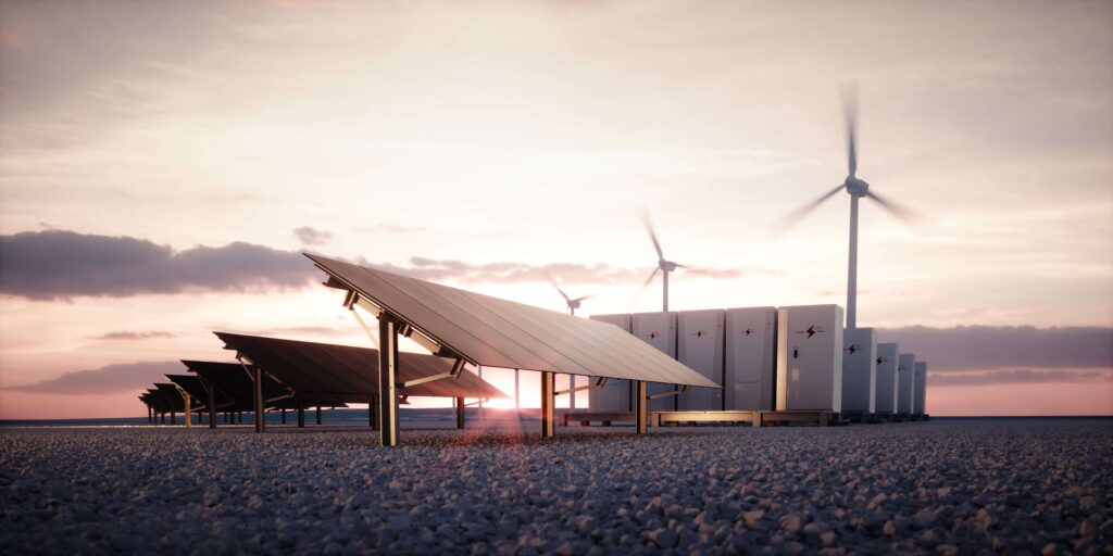 Solar panels, EV chargers, and wind turbines in a field