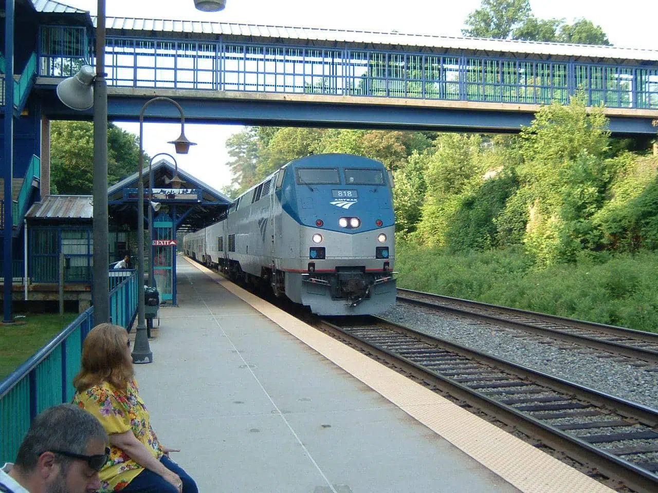 Virginia railway train car passing under a bridge
